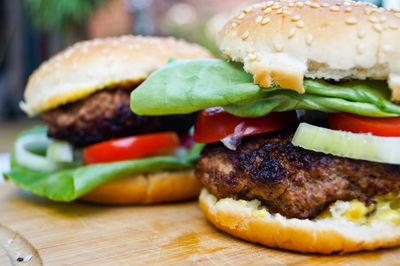 Close-up of burgers on cutting board