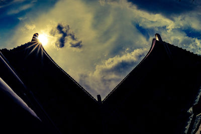 Low angle view of silhouette building against sky during sunset