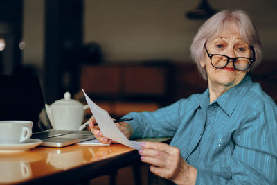 Portrait of senior woman working at cafe