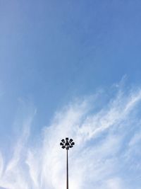 Low angle view of weather vane against blue sky