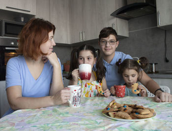 Mother and daughter eating food at home