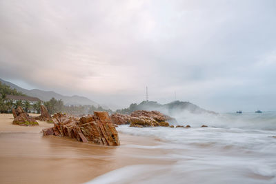 Scenic view of sea against cloudy sky