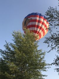 Low angle view of hot air balloon against clear blue sky