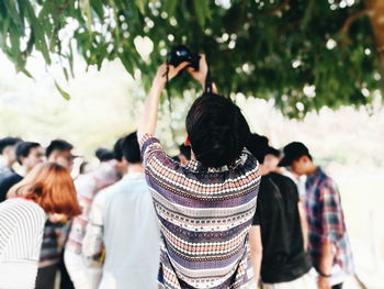 Rear view of people standing outdoors