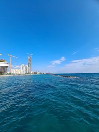 Scenic view of sea against blue sky