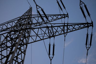 Low angle view of electricity pylon against sky