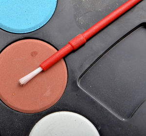 Close-up of paintbrush with watercolor paints