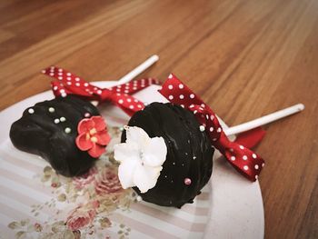 Close-up of chocolate lollipops served in plate on table