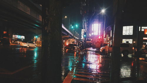 Wet illuminated city at night