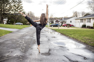 Full length of woman dancing ballet outdoors