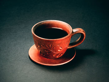 The earthenware cup of coffee. close up