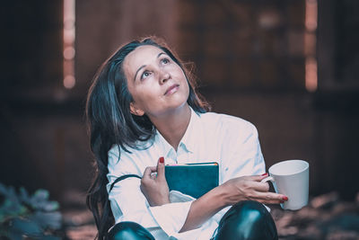 Young woman drinking coffee outdoors