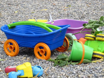 High angle view of various toys on pebbles