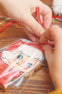 High angle view of woman holding ring on table