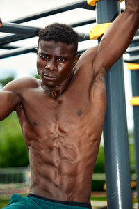 Shirtless muscular man exercising in gym