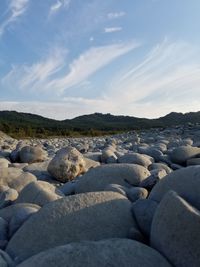 Pebbles on beach against sky
