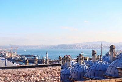 Panoramic view of city by sea against sky