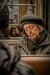 Man looking at camera while sitting in winter