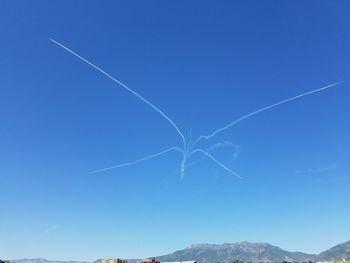 Low angle view of vapor trails in sky