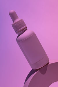 Close-up of security camera against pink background