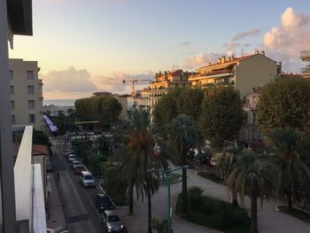 Panoramic view of city street and buildings against sky