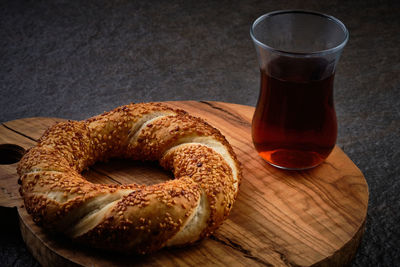 Traditional turkish bagel and  traditional turkish tea served on a dark stone surface