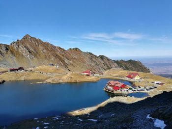 Scenic view of lake and mountains against sky