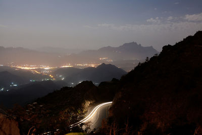 Panoramic view of road and mountains against sky at night