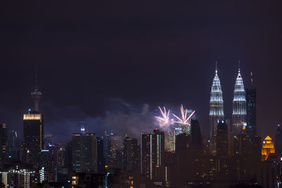 View of skyscrapers lit up at night