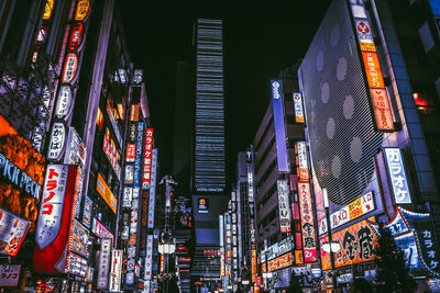 Low angle view of illuminated modern buildings at night