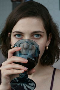 Close-up portrait of beautiful woman having drink