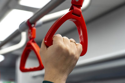 Cropped image of man holding handgrip in bus