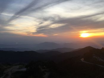 Scenic view of silhouette mountains against sky at sunset