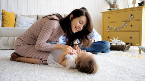 Happy woman lying down on floor