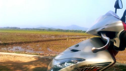 Car on road by land against sky