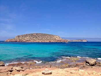 Scenic view of sea against blue sky