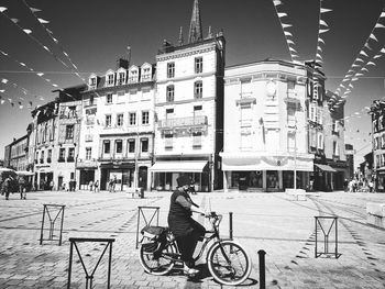 Man riding bicycle on city street