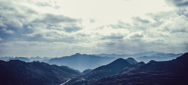 Scenic view of mountains against cloudy sky