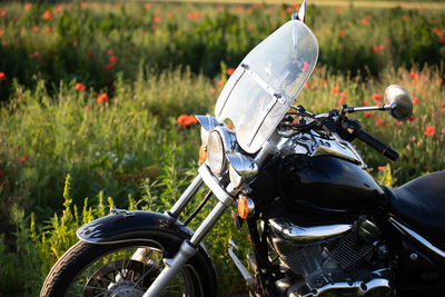 Low section of man riding motorcycle on field
