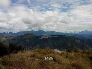 Scenic view of mountains against cloudy sky