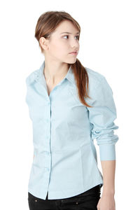 Portrait of young woman standing against white background