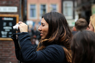 Portrait of woman standing in city