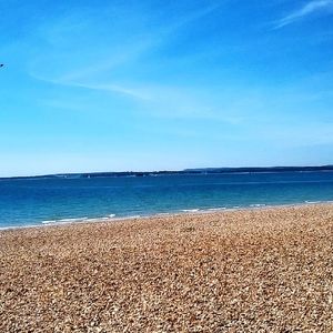 Scenic view of sea against blue sky