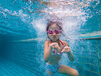 Portrait of girl swimming in pool