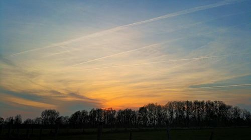 Scenic view of landscape against sky at sunset