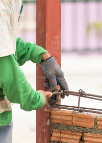 Man working on metal wall