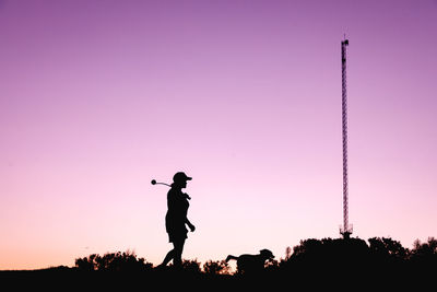 Silhouette man standing against pink sky during sunset