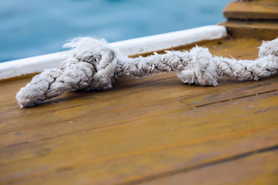 Close-up of rope tied on wooden table