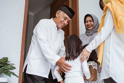 Group of people in traditional clothing standing outdoors