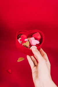 Midsection of woman holding heart shape